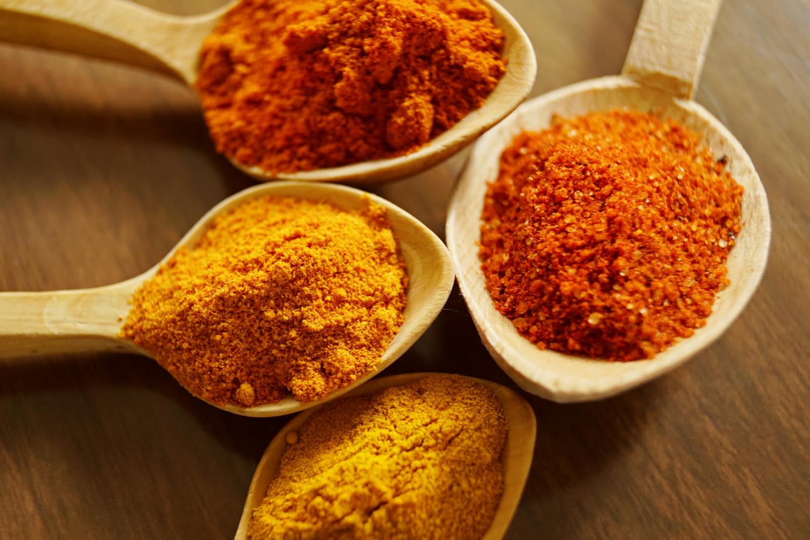 Unveiling the Wonders of Curcuma Longa: A Natural Marvel for Health and Wellness 1 Four Assorted Spices On Wooden Spoons